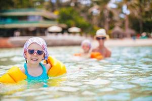 Cute little girl at beach during summer vacation photo