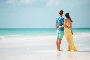 Young couple on white beach during summer vacation. photo