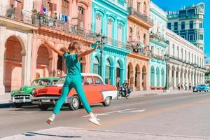 Tourist girl in popular area in Havana, Cuba. Young kid traveler smiling photo