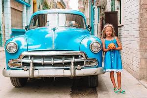 Tourist girl in popular area in Havana, Cuba. Young kid traveler smiling photo