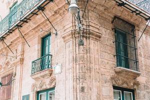 Authentic view of a street of Old Havana with old buildings and cars photo