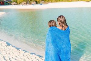 Adorable little girls have a lot of fun on the beach. photo