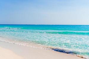 Idyllic tropical beach with white sand, turquoise ocean water and blue sky on Caribbean island photo