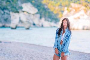 Woman laying on the beach enjoying summer holidays looking at the sea photo