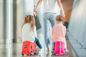 Happy family with two kids in airport have fun waiting for boarding photo