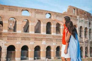 Happy family in Europe. Romantic couple in Rome over Coliseum background photo