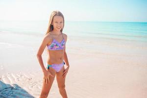 Adorable little girl at beach on her summer vacation photo