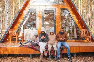 Happy family sitting on the terrace of their house in autumn photo