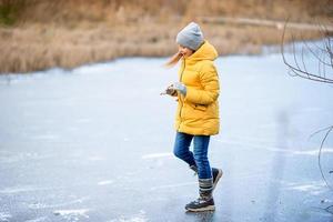 Adorable little girls skating on the ice-rink photo