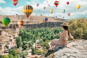 Young woman on the edge of canyon in Cappodocia photo