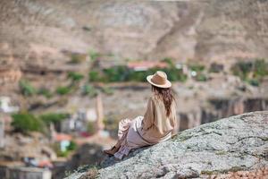 Young woman on the edge of canyon in Cappodocia photo