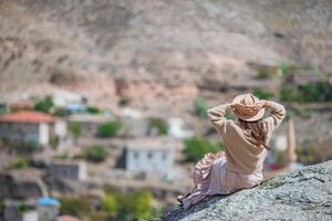 Young woman on the edge of canyon in Cappodocia photo