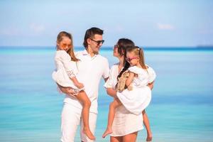 Young family of four on beach vacation photo