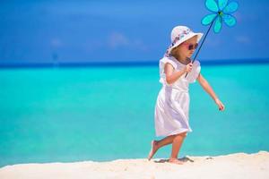 Adorable happy little girl have fun on beach vacation photo