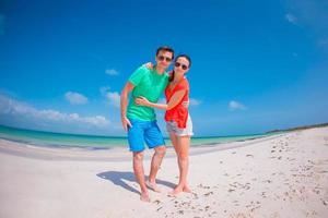 Young couple on white beach during summer vacation. photo