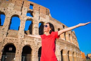 Adorable little active girl with map in front of Colosseum in Rome, Italy. Kid spending childhood in Europe photo