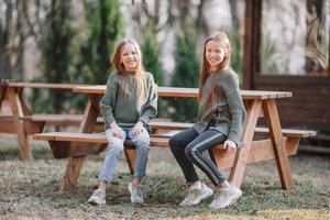 Little girls in outdoor park on her weekend photo