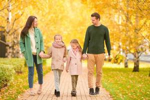 Family in autumn park in fall photo