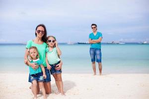 Happy family of four during summer vacation photo