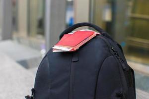 Closeup passports and boarding pass on backpack at airport photo