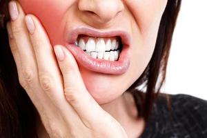 Woman with a toothpain, isolated on white background photo