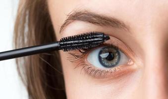 Beautiful woman applied mascara photo