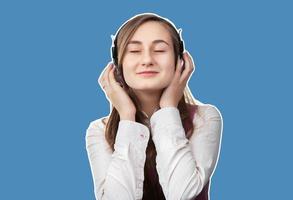 Girl listening to music in headphones photo