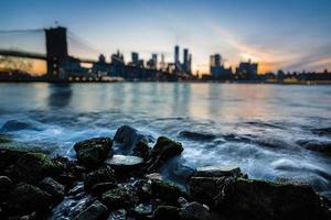 Blurred Manhattan skyline with Brooklyn Bridge photo