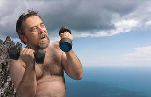 man exercising with dumbbells photo