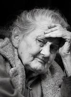 Very old and tired wrinkled woman outdoors photo