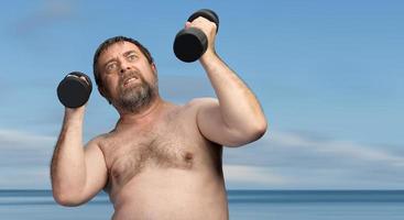 man exercising with dumbbells photo