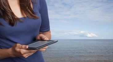 Young woman reading ebook photo