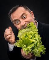 Man holding and eating lettuce photo