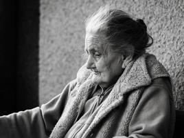 Very old and tired wrinkled woman outdoors photo