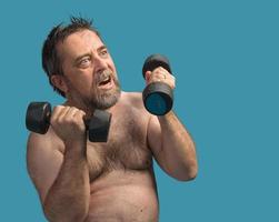 man exercising with dumbbells photo