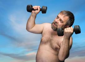 man exercising with dumbbells photo