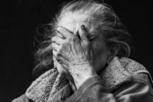 Very old and tired wrinkled woman outdoors photo