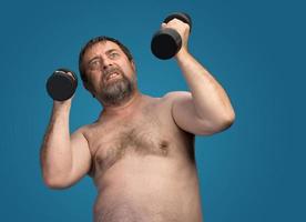 man exercising with dumbbells photo