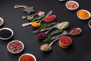 Composition consisting of a variation of spices in metal spoons laid out in the shape of a Christmas tree photo