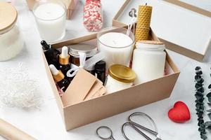 Gift box with candle making tools, candle, soy wax, wicks and aroma oil bottles photo