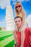 Family portrait background the Learning Tower in Pisa. Pisa - travel to famous places in Europe. photo