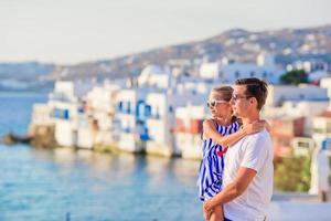 Family in Europe. Father and kid on Little Venice background on Mykonos Island, in Greece photo