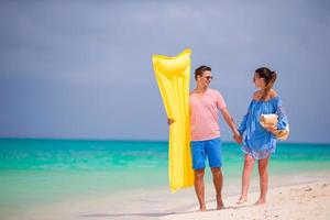Young couple on white beach at summer vacation photo