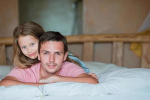Father and adorable little girl having fun at home photo