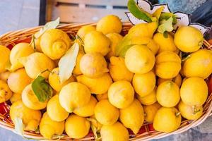 Wicker basket full of lemons on the italian street od Corniglia photo