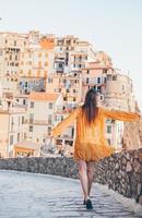 Tourist looking at scenic view of Manarola, Cinque Terre, Liguria, Italy photo