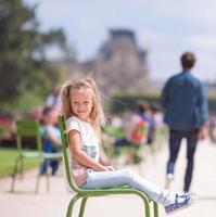 Adorable fashion little girl outdoors in the Tuileries Gardens, Paris, France photo
