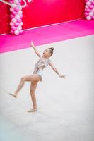 Little gymnast training on the carpet and ready for competitions photo