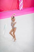 Little gymnast training on the carpet and ready for competitions photo