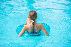 Little adorable girl in outdoor swimming pool photo